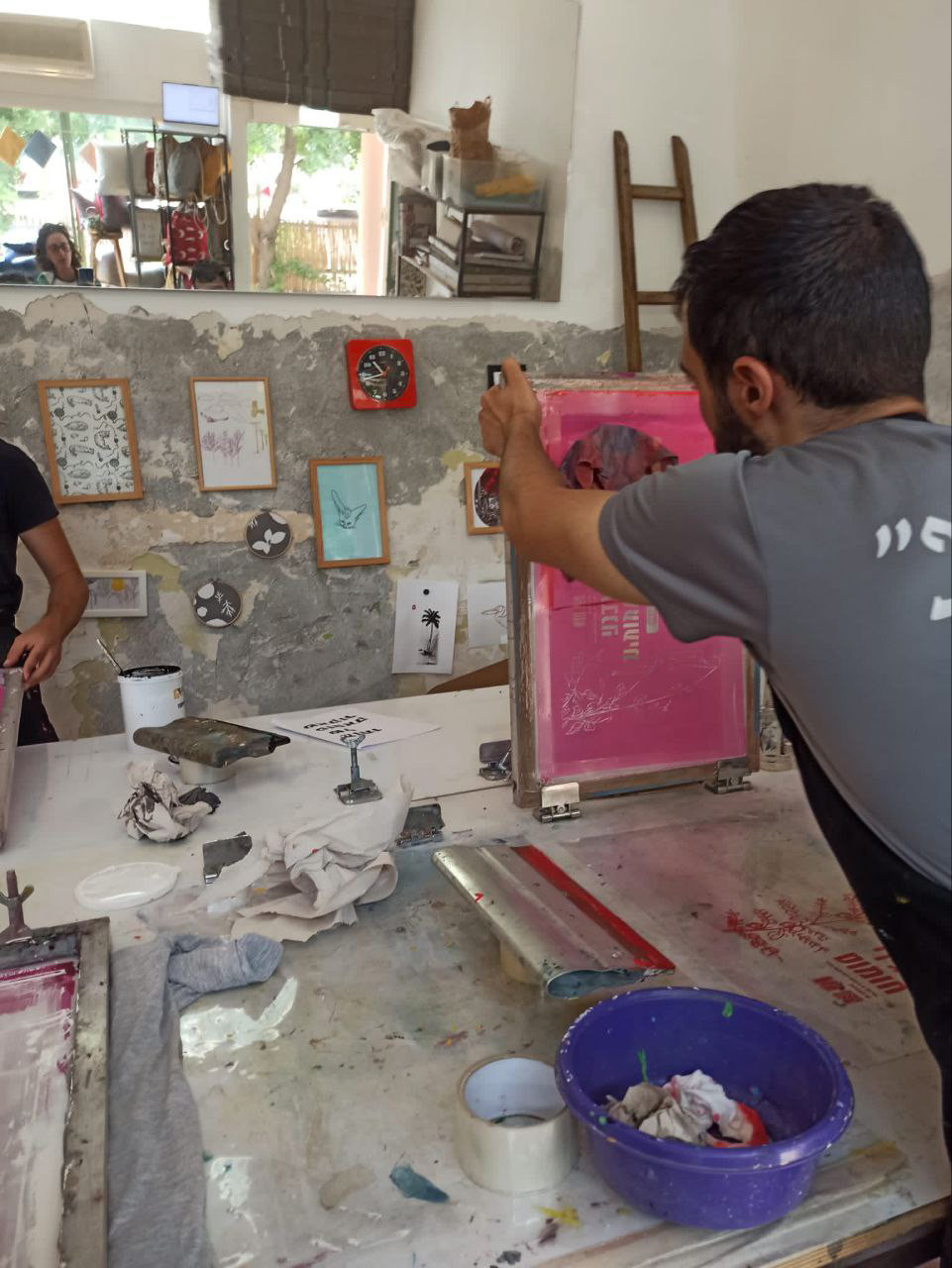 Screen printing the label onto the cloth by hand